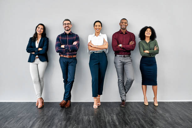 Nothing says capability like confidence Studio shot of a group of businesspeople standing in line against a grey background candidate photos stock pictures, royalty-free photos & images