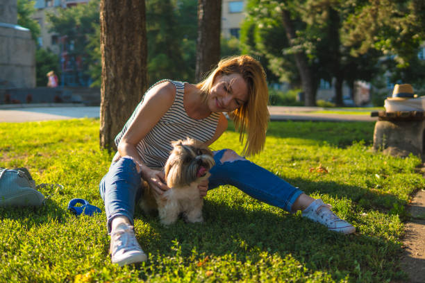 istock Woman with dog in a park 1181788997