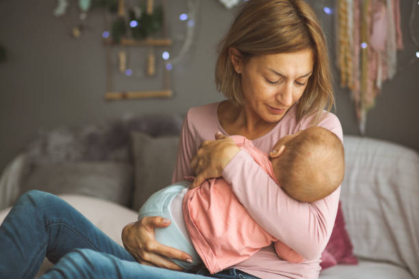 istock Mother holding small baby 1181795758