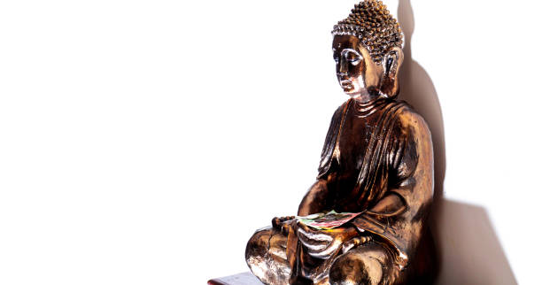istock Beautiful golden buddha statue on a white wall. 1181801667