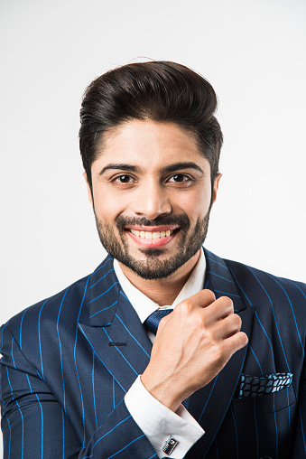 Indian Male businessman standing against gray background