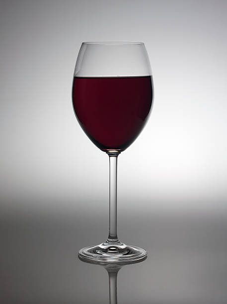 istock Glass with red wine in back light. 118180454