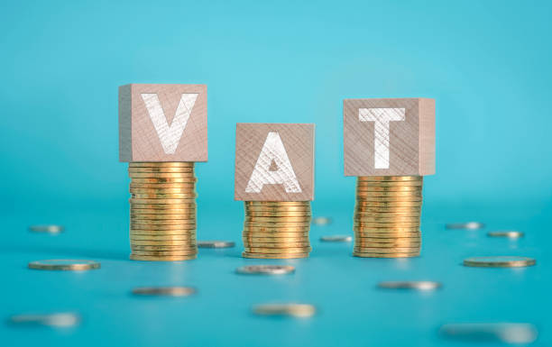 Wooden Blocks and Coins Forming VAT Text Over Blue Background Vat, Savings, Refund, Coin, Currency vat stock pictures, royalty-free photos & images