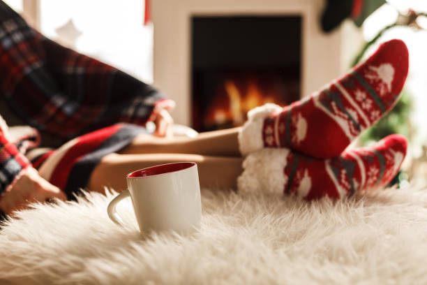 istock Feet on Christmas socks near fireplace 1181807185