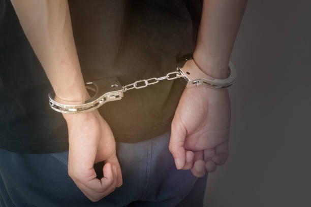 istock hands of arrested man with handcuffs 1181807248