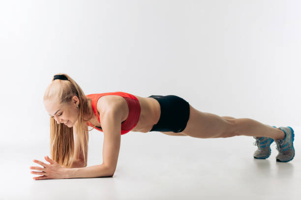 istock happy fit girl is doing some push-ups 1181810727