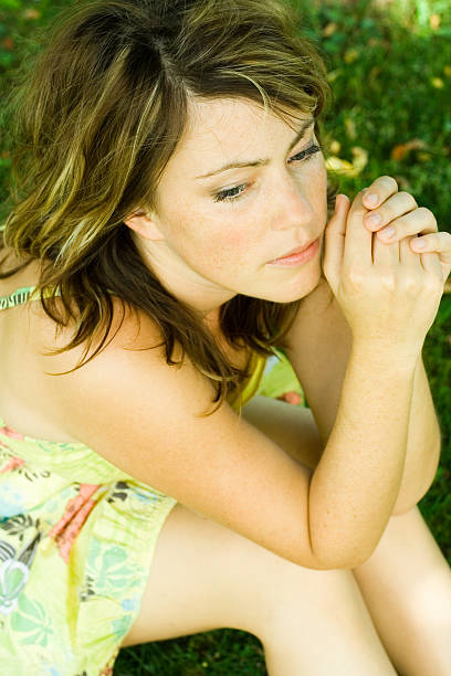 istock woman sitting in meadow 118181080
