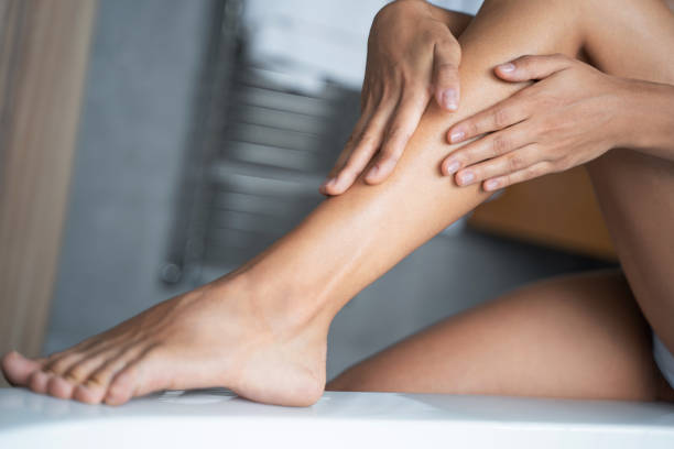 istock Female applying a lotion on the leg 1181811608
