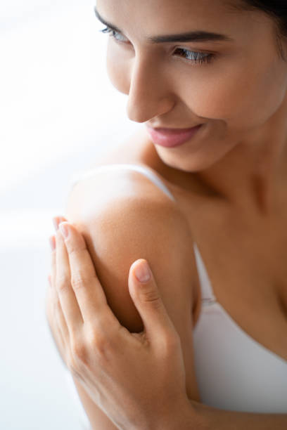 istock Pleased good-looking young female applying a moisturizer 1181811681