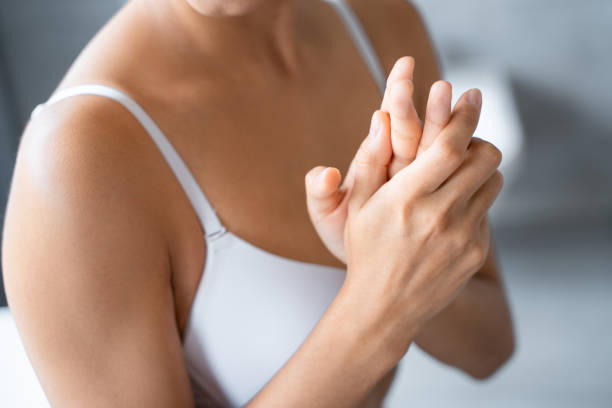 istock Young Caucasian woman using a hand cream 1181811715