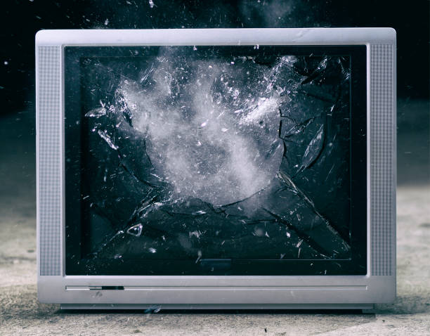 Demolition of a television set. Crashing monitor glass.