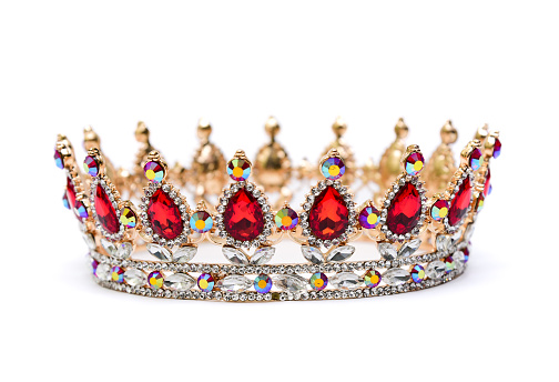 Gold crown of queen with red and white jewel of precious stones.