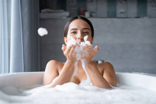 istock Relaxed young woman taking a bath with foam 1181813401
