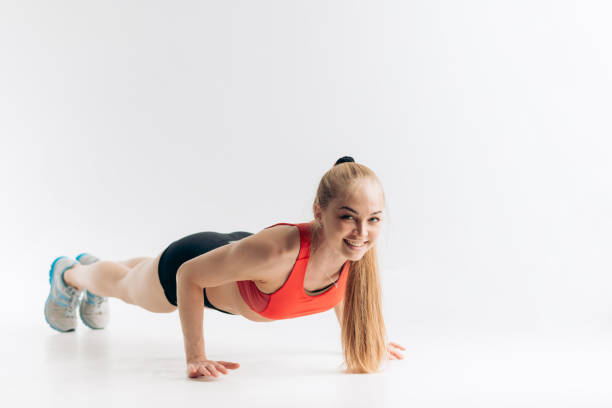istock Beautiful slim brunette doing some push ups a the gym 1181813408