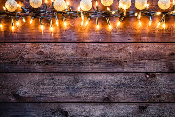 istock Empty rustic wooden table with Christmas lights border 1181814353