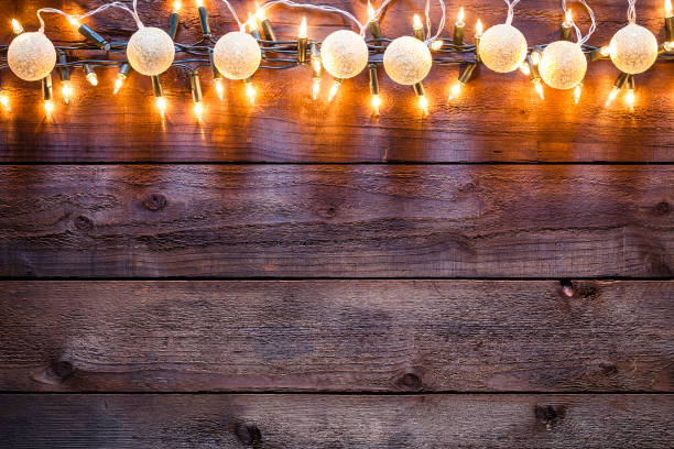 istock Empty rustic wooden table with Christmas lights border 1181814356