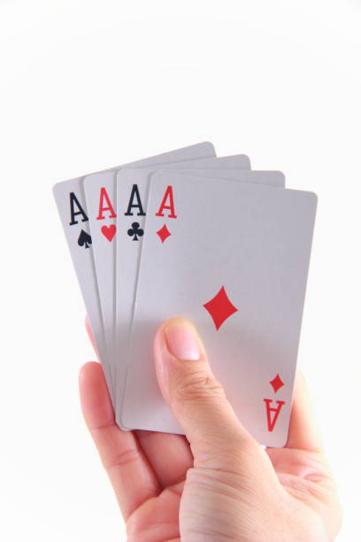 istock Four aces playing cards in hand 1181814530