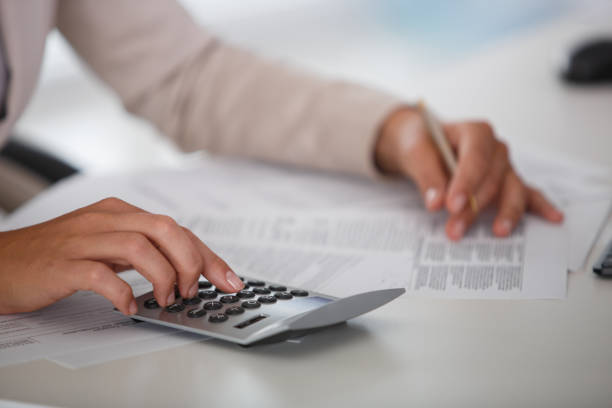istock Businesswoman using a calculator 1181815645