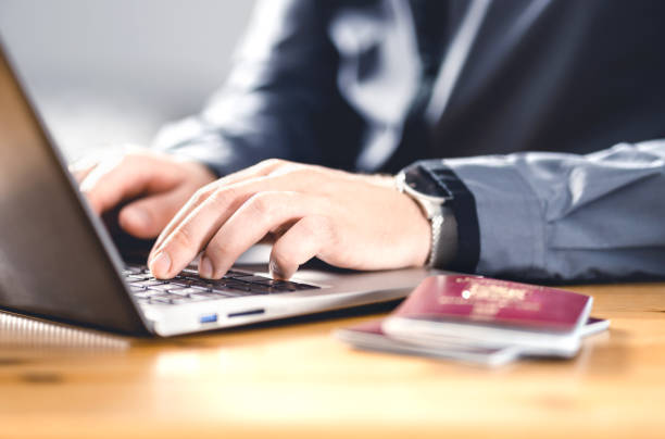 Man with passport and laptop. Travel document and identification. Immigrant writing electronic application for citizenship. Apply for digital visa.