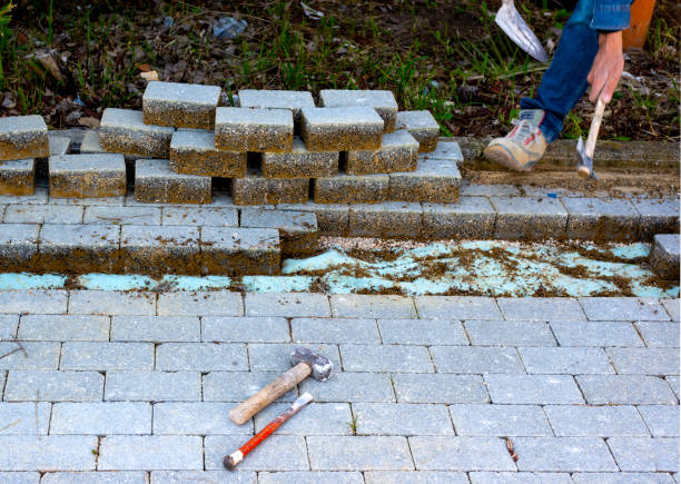 maintenance work on paving with interlocking paving stones. building materials industry; concrete products for road or sidewalk construction. - driveway brick paving stone interlocked imagens e fotografias de stock