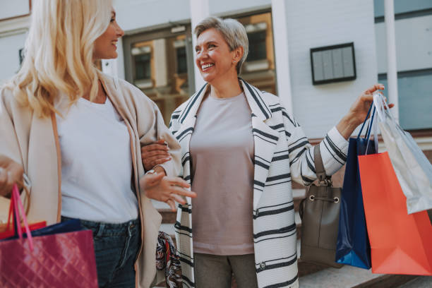 istock Female looking at her friend with purchases 1181823266