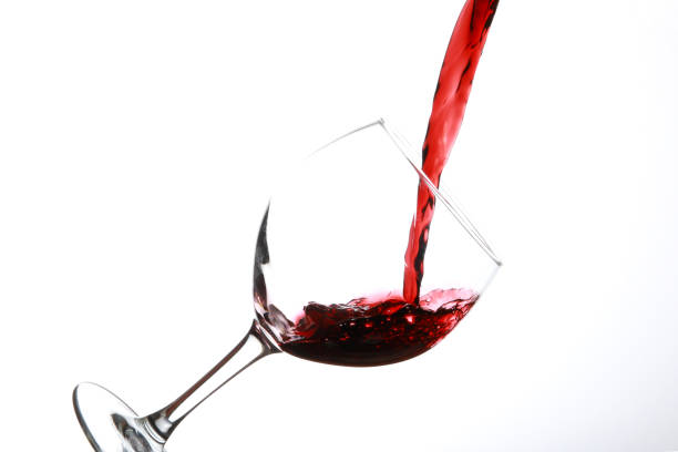 istock Pouring Red Wine into tilted glass from various decanters 1181824218
