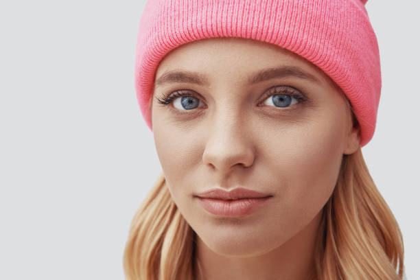 istock Attractive young woman looking at camera while standing against grey background 1181824348
