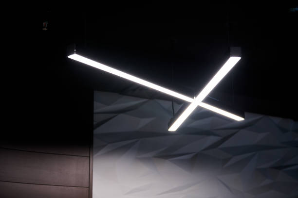 istock Modern office lighting. Thin lamps in office dark ceiling. LED white cold light over workplaces. 1181825775