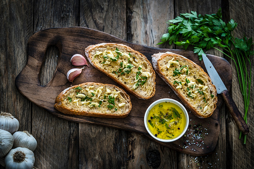 Appetizer: garlic bread on rustic wooden table