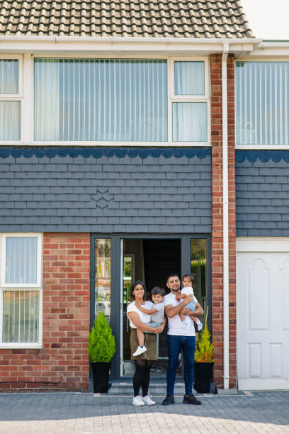 istock Proud Family Outside Their Home 1181829241