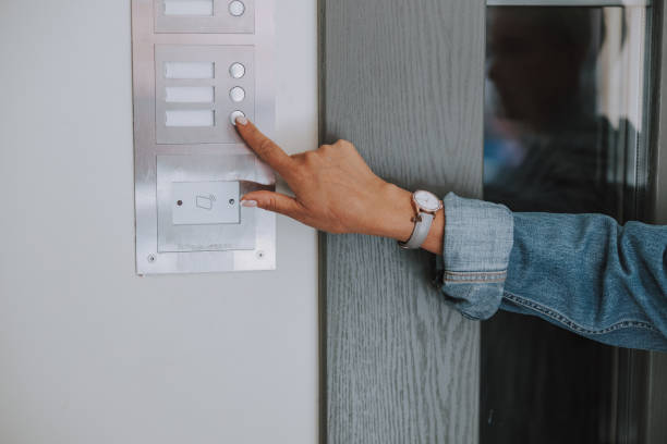 istock Hand of a Caucasian lady ringing the intercom 1181831113