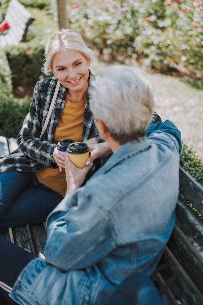 istock Lady talking to a friend in a park 1181831145
