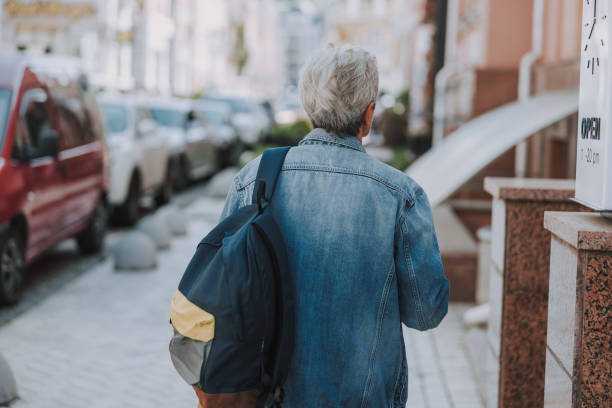 istock Aged Caucasian woman walking along the sidewalk 1181831221