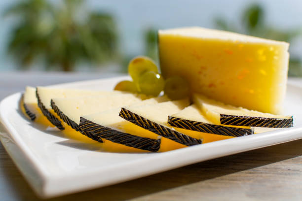Spanish sheep cheese served with white outside with sea view close up