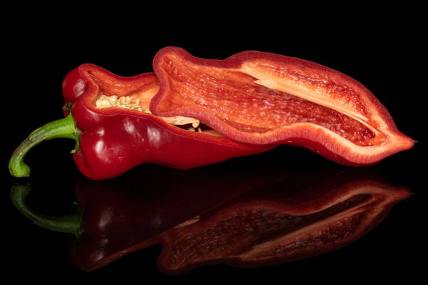 istock Sweet red bell pepper isolated on black glass 1181840236