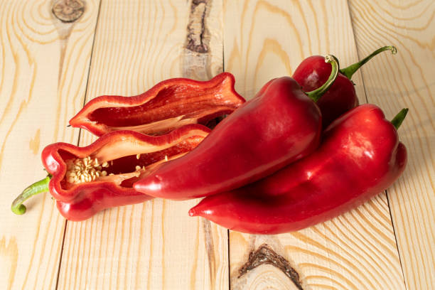 Sweet red bell pepper on wood stock photo