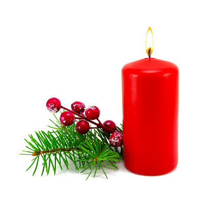 Christmas decoration with candles and branches of fir tree. Christmas fir tree branch with red candle isolated on white background.