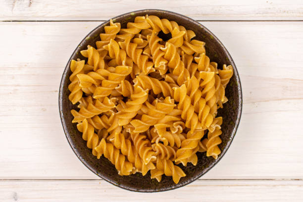 istock Dry wholegrain fusilli on grey wood 1181842852