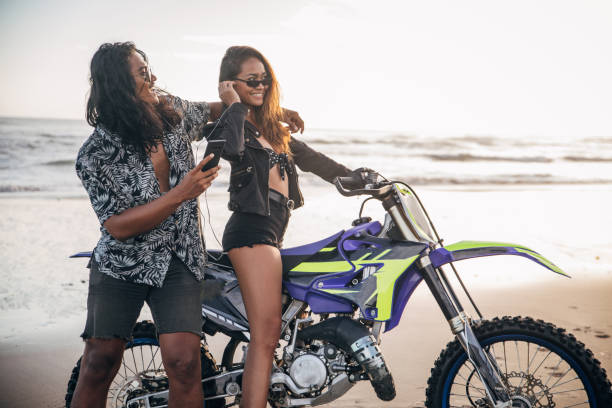 istock Modern couple with motorcycle on the beach 1181843143