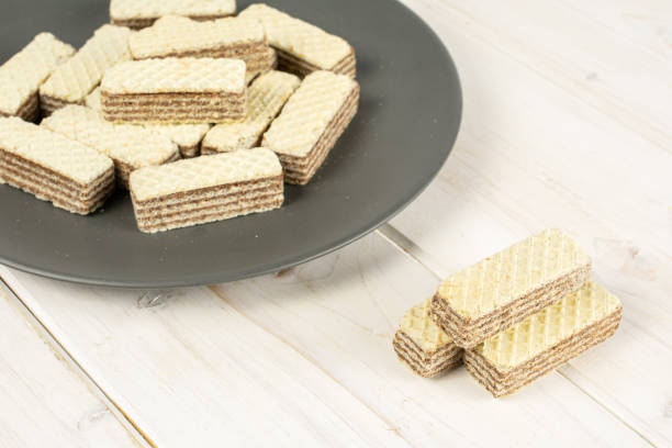 istock Hazelnut wafer cookie on grey wood 1181843144