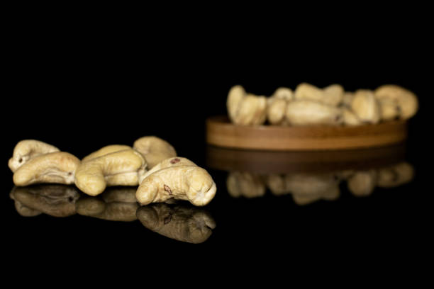 istock Fresh cashew nut isolated on black glass 1181845453