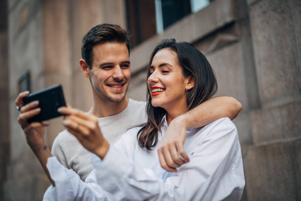 istock Modern couple taking a selfie on the street 1181846482