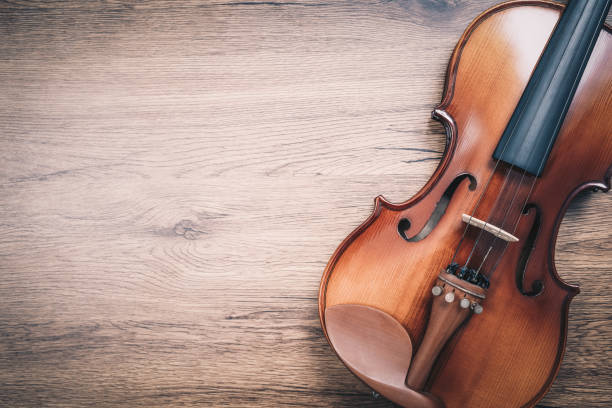 istock classical violin on wooden floor. music background 1181846575