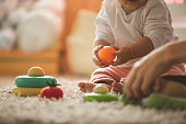 Cropped picture of mom and daughter playing with toys