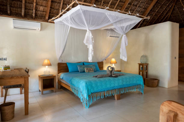 istock Master bed in tropical island hotel suite 1181846878