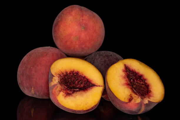 istock Sweet red peach isolated on black glass 1181848384