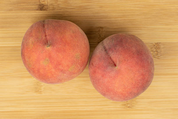 istock Sweet red peach on light wood 1181848498