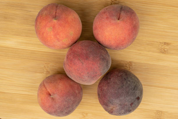 istock Sweet red peach on light wood 1181848523