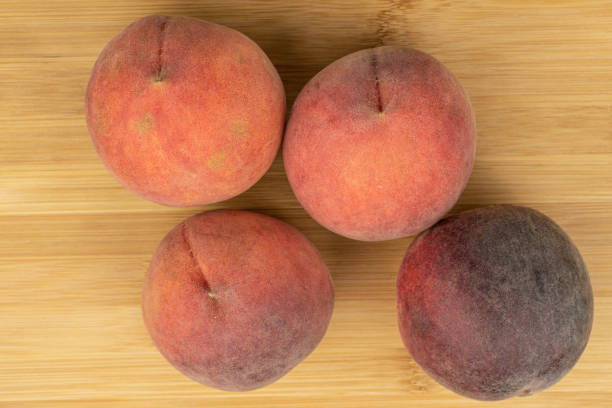 istock Sweet red peach on light wood 1181848548