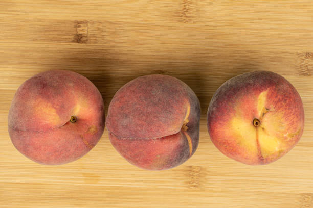 istock Sweet red peach on light wood 1181848563